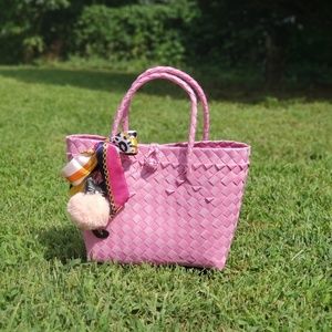Pink woven hand bag with charm and twilly